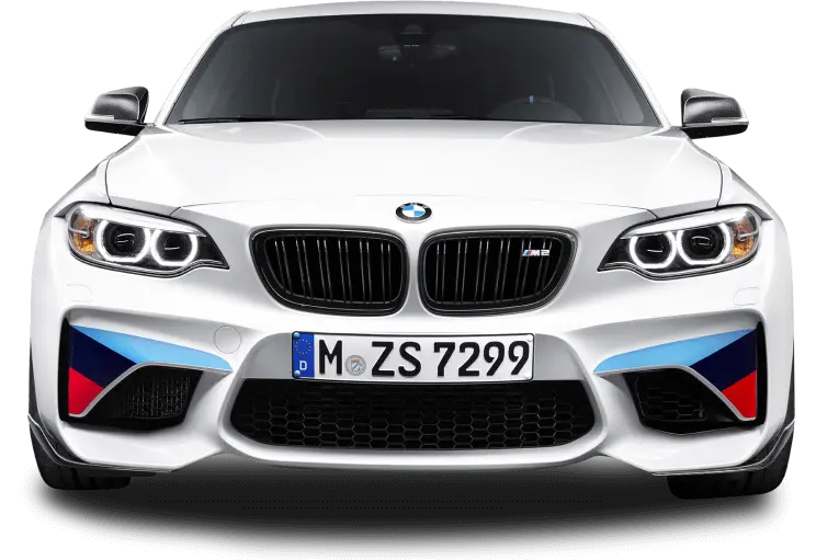 A front-facing view of a white BMW M2 with black kidney grilles, aggressive headlights, and BMW M Performance accents on the front bumper. The car features a European license plate reading "M ZS 7299," and the signature M stripes in blue, purple, and red on the lower air intakes.