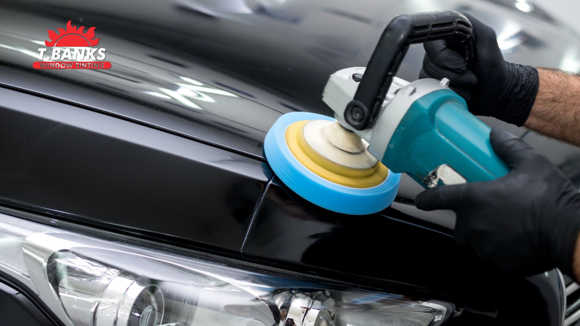 Close-up of a professional using a power buffer to polish a black car's hood, with the T. Banks Window Tinting logo in the corner.