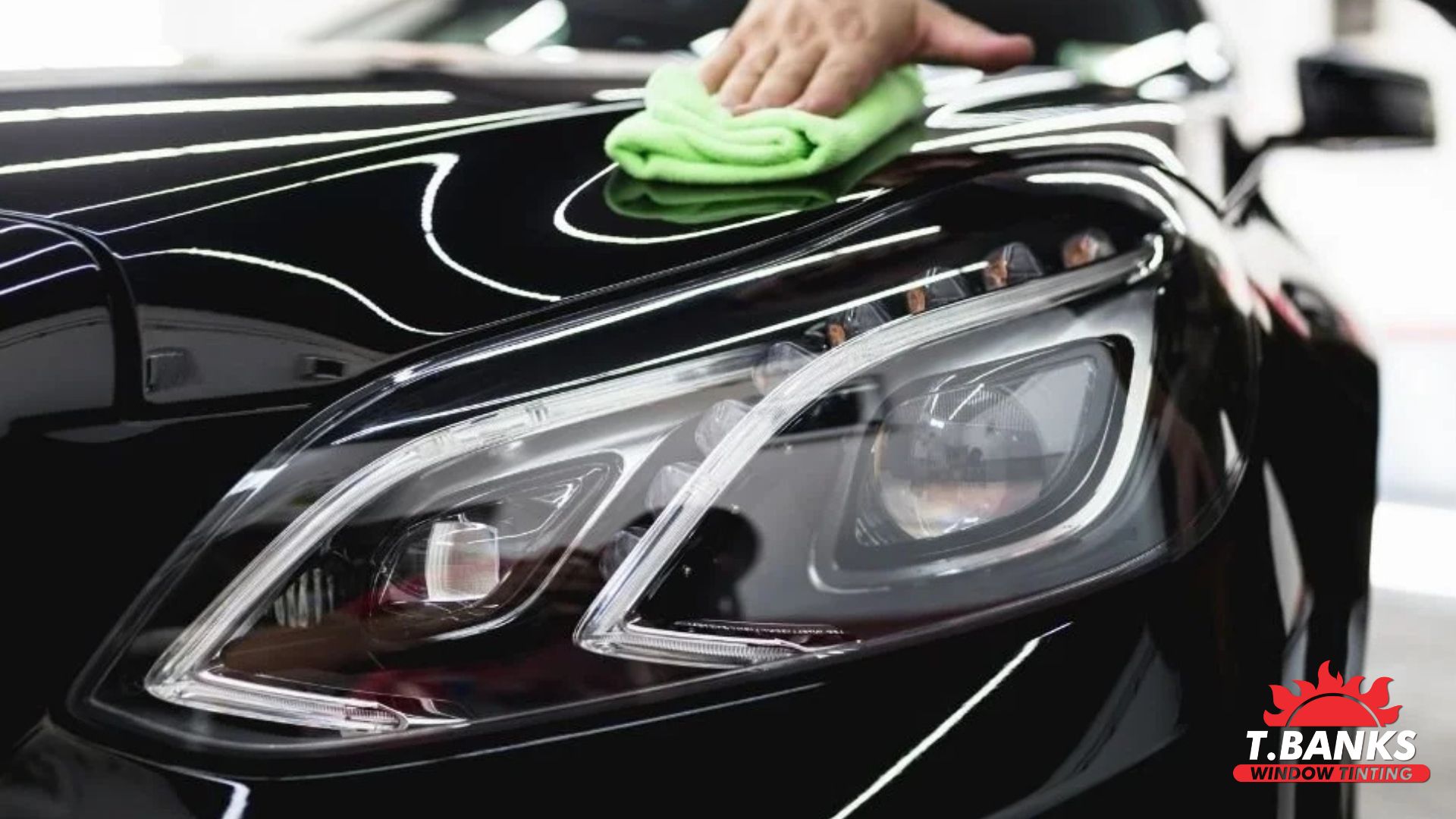 hand cleaning car hood after applying ceramic coating
